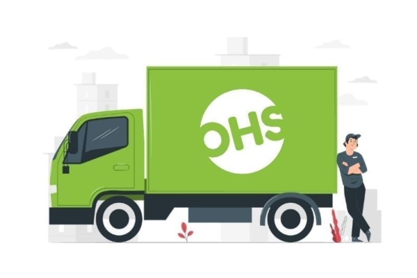 A person leans against a green delivery lorry with OHS on the side, as faint city buildings and small plants surround them, while a VoIP call buzzes softly in their ear.
