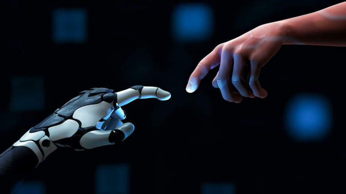A human hand and a robotic hand reach towards each other with outstretched fingers, nearly touching against a dark background with blue highlights.
