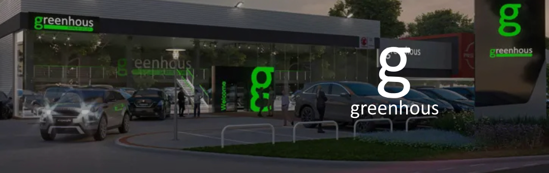 A modern car dealership with several vehicles parked outside. The building features the Greenhous logo in bright green and white signage.