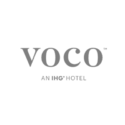 Logo of voco, an IHG Hotel, in grey text on a transparent background.