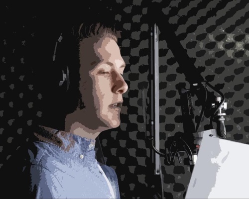 A professional voiceover artist, wearing headphones, speaks smoothly into the microphone inside a soundproof booth, holding a script in hand.