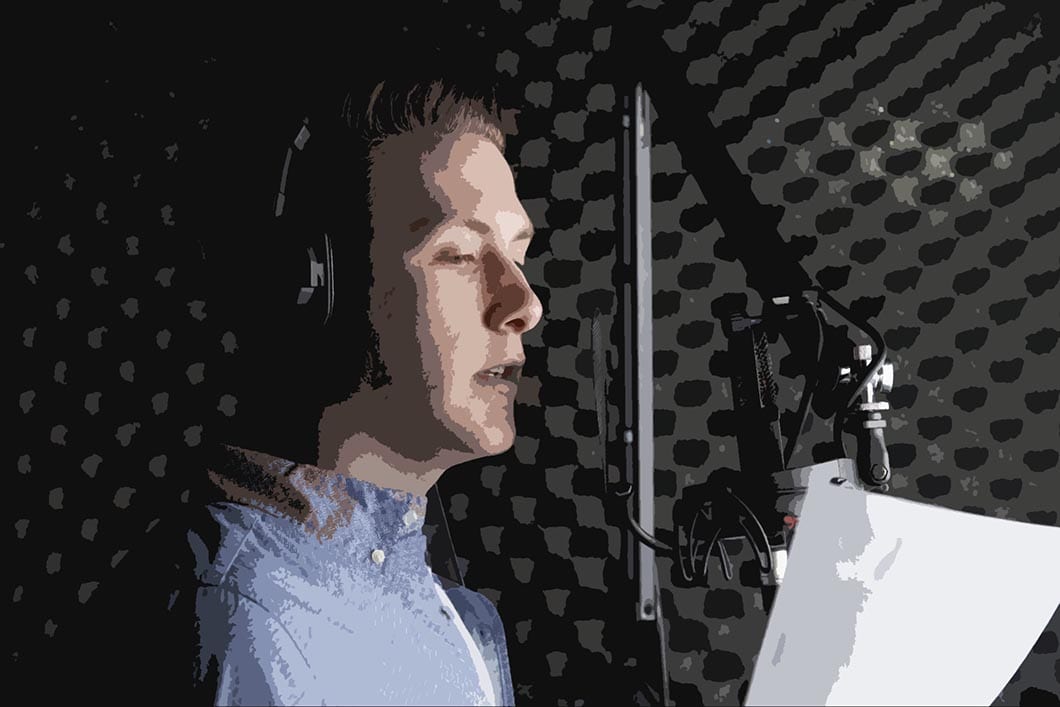 A professional voiceover artist, wearing headphones, speaks smoothly into the microphone inside a soundproof booth, holding a script in hand.